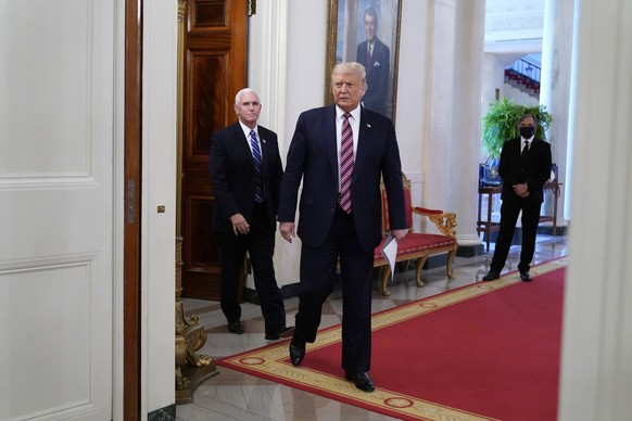 President Donald Trump and Vice President Mike Pence arrive to attend an event called &quot;Kids First: Getting America&#039;s Children Safely Back to School&quot; in the State Dining room of the Whit ...