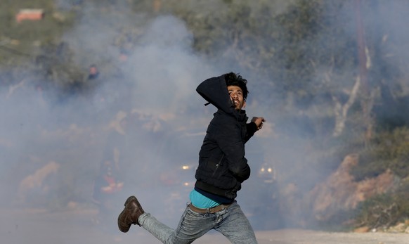 epa08285434 Palestinian protesters during clashes with Israeli troops at Beta village near the West Bank city of Nablus, 11 March 2020. According to media reports, 20 Palestinians were wounded, three  ...