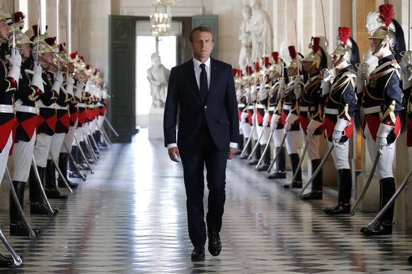 epa06875825 French President Emmanuel Macron walks through the Galerie des Bustes (Busts Gallery) to access the Versailles Palace&#039;s hemicycle, to address both the upper and lower houses of the Fr ...