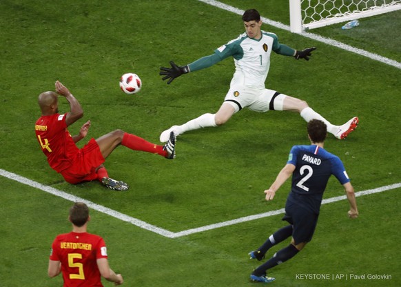 Belgium goalkeeper Thibaut Courtois, top right, makes a save in front of France&#039;s Benjamin Pavard, right, during the semifinal match between France and Belgium at the 2018 soccer World Cup in the ...
