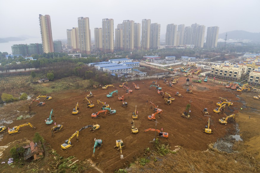 Heavy equipment works at a construction site for a field hospital in Wuhan in central China&#039;s Hubei Province, Friday, Jan. 24, 2020. China is swiftly building a 1,000-bed hospital dedicated to pa ...