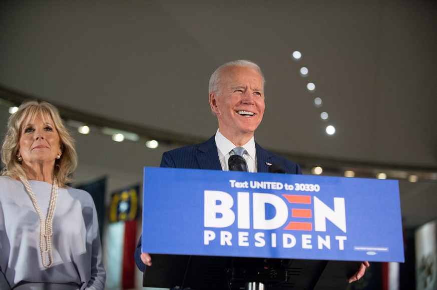 epa08468182 Democratic Party presidential candidate Joe Biden (R), accompanied by his wife Jill Biden (L), speaks at a primary night event at the National Constitution Center in Philadelphia, Pennsylv ...