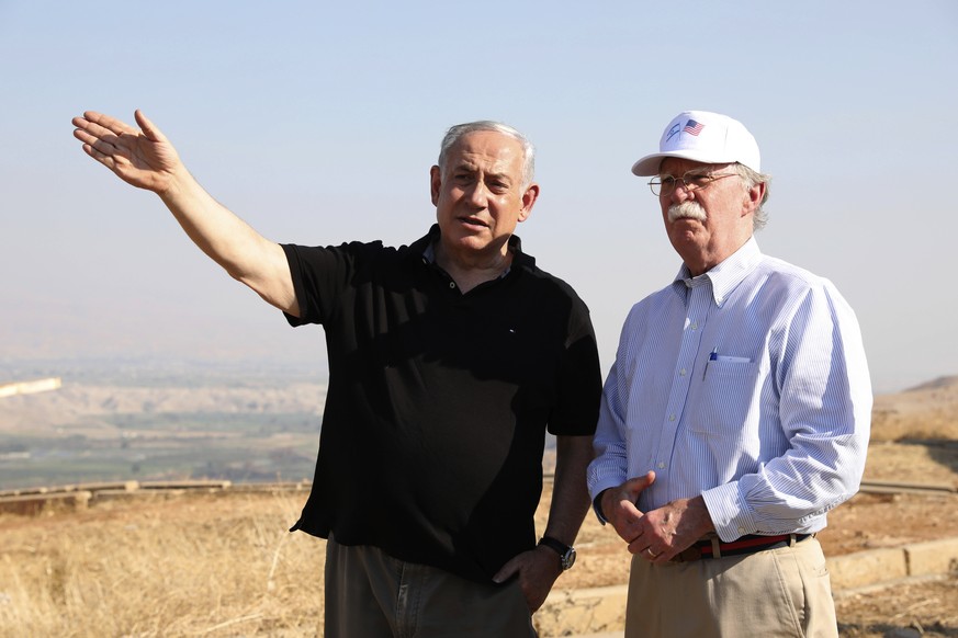 FILE - in this Sunday, June 23, 2019 file photo, US National Security Advisor John Bolton, right, and Israeli Prime Minister Benjamin Netanyahu, visit an old army outpost overlooking the Jordan Valley ...