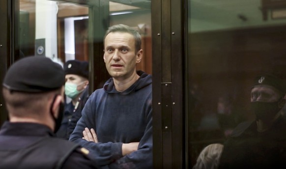 In this handout photo taken from a footage provided by Moscow City Court, Russian opposition leader Alexei Navalny stands in the cage during a hearing to a motion from the Russian prison service to co ...