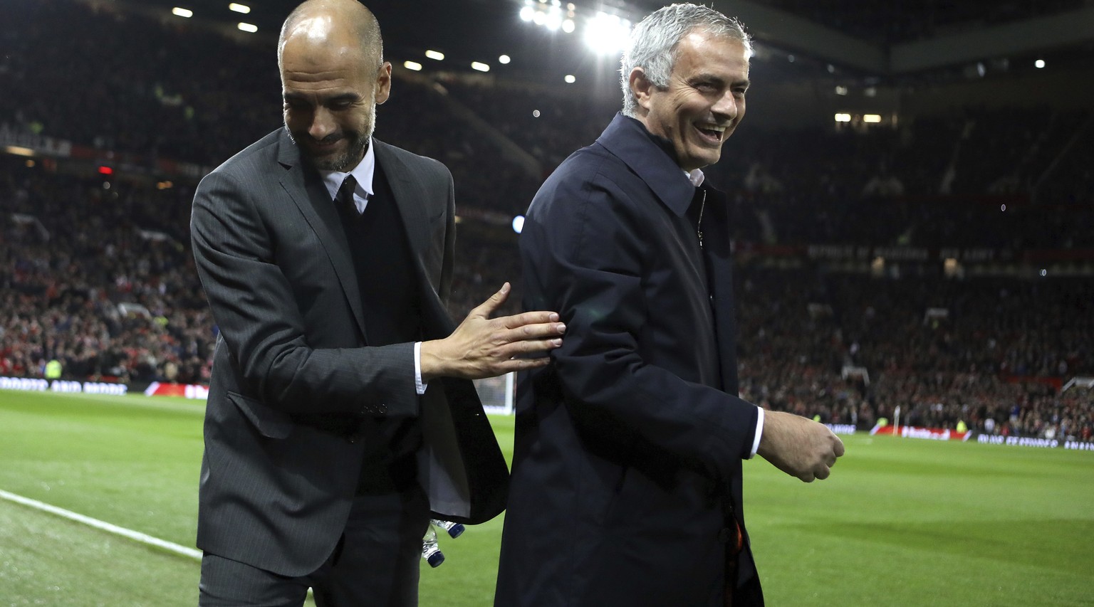 Manchester City&#039;s manager Pep Guardiola, left, and Manchester United&#039;s manager Jose Mourinho smile ahead of the English League Cup soccer match between Manchester United and Manchester City  ...