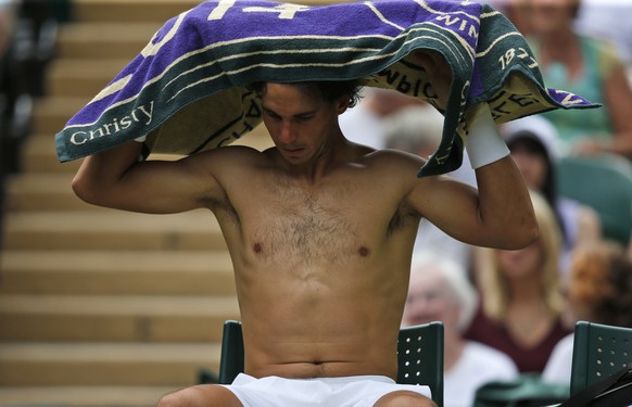 Rafael Nadal of Spain changes his shirt between games during the men&#039;s singles match against Lukas Rosol of the Czech Republic at the All England Lawn Tennis Championships in Wimbledon, London, T ...