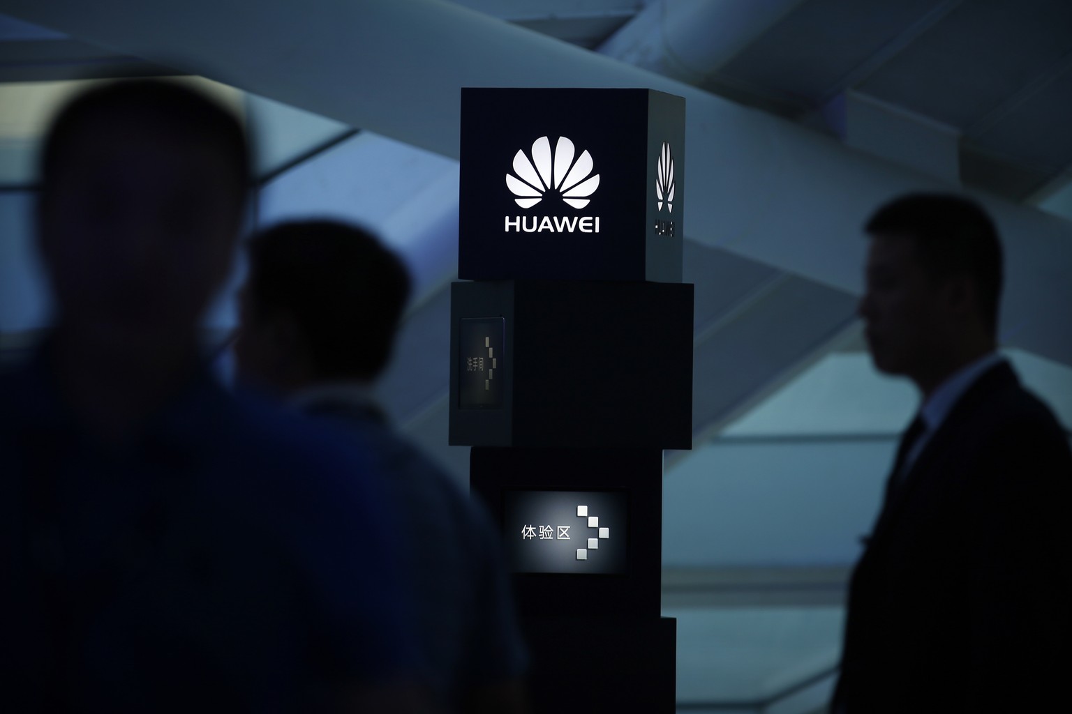 FILE - In this June 26, 2016 file photo, visitors attend a launch event for the Huawei MateBook in Beijing. France&#039;s President Emmanuel Macron is cautioning against freezing out Chinese tech gian ...
