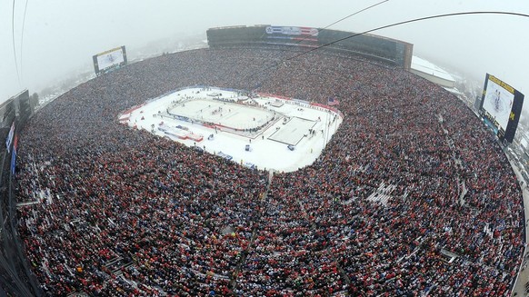 In a photo provided by National Hockey League Images and taken with a fisheye lens, a record crowd watches the Detroit Red Wings and the Toronto Maple Leafs play in the Winter Classic outdoor NHL hock ...