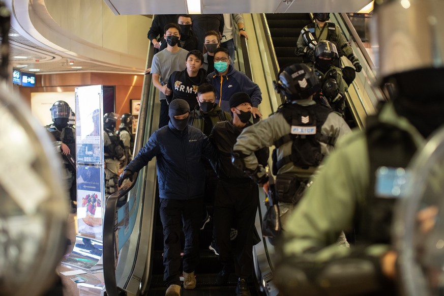 epa08089177 Riot police detain pro-democracy protesters during a rally in a shopping mall in Hong Kong, China, 24 December 2019. Police fired multiple rounds of tear gas in the tourist district of Tsi ...