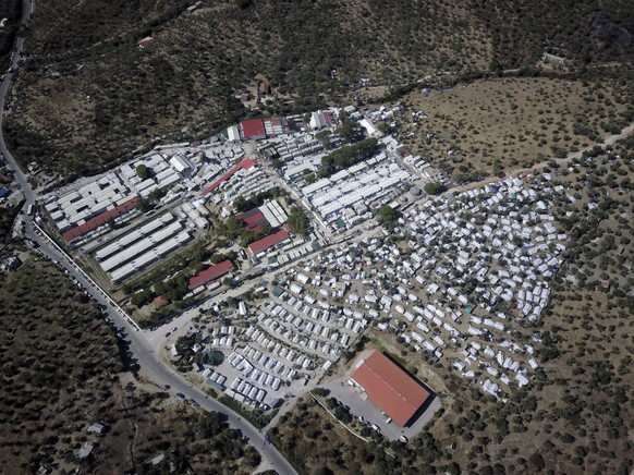 An aerial view of the Moria refugee camp on the northeastern Aegean island of Lesbos, Greece, Monday, Sept. 30, 2019. About 12,000 migrants, most of them Afghans, are housed in a space designed for 3, ...