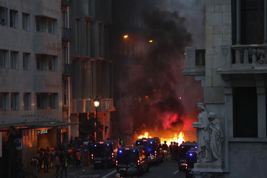 A barricade burns on the fifth day of protests over the conviction of a dozen Catalan independence leaders in Barcelona, Spain, Friday, Oct. 18, 2019. Tens of thousands of flag-waving demonstrators de ...