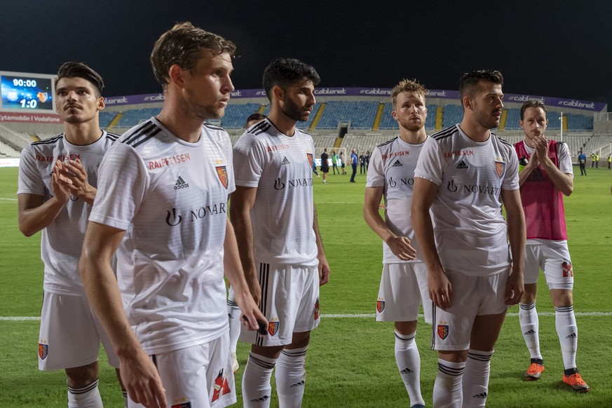 Basel&#039;s disappointed players with captain Fabian Frei, front, leave the pitch after the UEFA Europa League play-off second leg match between Cyprus&#039; Apollon Limassol FC and Switzerland&#039; ...