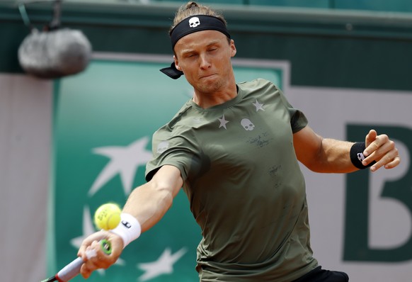 epa05999300 Jozef Kovalik of Slovakia in action against Stanislas Wawrinka of Switzerland during their men’s 1st round single match during the French Open tennis tournament at Roland Garros in Paris,  ...