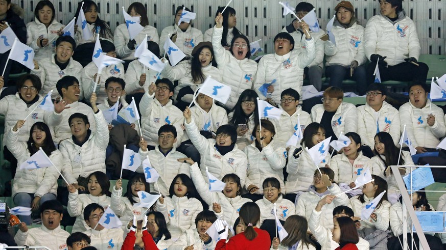 epa06495496 People cheer with the Flag of Korean Peninsula prior the Women&#039;s Ice Hockey friendly match Korea vs Sweden at Seonhak International Ice Rink in Incheon, South Korea, 04 February 2018. ...