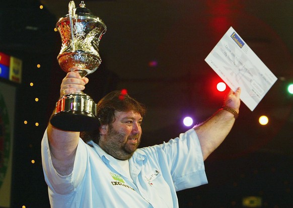 FRIMLEY GREEN, ENGLAND - JANUARY 11: Andy Fordham of England holds the trophy and winner&#039;s cheque after beating Mervyn King in the final of The BDO Lakeside World Darts Championships at the Lakes ...