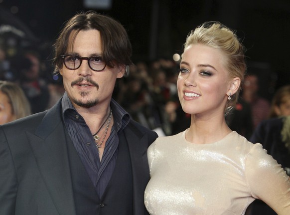 ARCHIV - US-Schauspieler Johnny Depp und Amber Heard kommen zur Europapremiere des Films