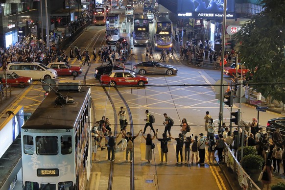 Demonstrators link hands across a street in Hong Kong, Friday, Aug. 23, 2019. Supporters of Hong Kong&#039;s pro-democracy movement created human chains on both sides of the city&#039;s harbor Friday, ...