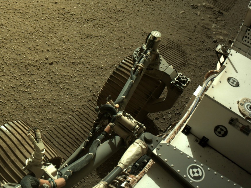 epa09068873 A handout photo made available by NASA shows an image of NASA&#039;s Perseverance Mars rover and its tire tracks in the Martian soil, acquired by using its onboard Right Navigation Camera  ...