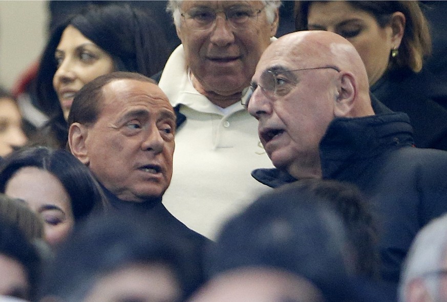 AC Milan president Silvio Berlusconi, left, is flanked by vice president Adriano Galliani during a Serie A soccer match between AC Milan and Inter Milan, at the San Siro stadium in Milan, Italy, Sunda ...