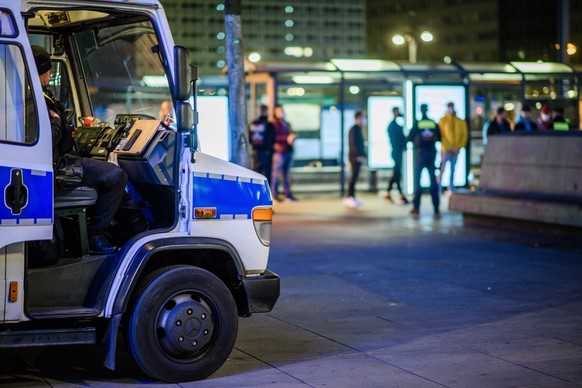 epa09157876 A small group of people, who have been out and about after one o?clock at nighttime, stand lined-up in front of policemen, in order to get their personal data recorded, at Alexanderplatz s ...