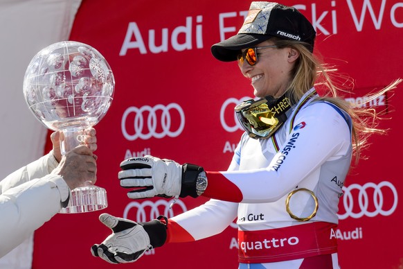Lara Gut of Switerland, right, receives the women&#039;s Alpine Skiing World Cup Overall trophy from FIS president Gian-Franco Kasper, left, during the podium ceremony at the FIS Alpine Ski World Cup  ...