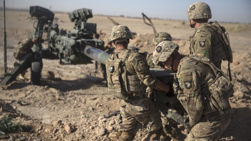 This June 10, 2017 photo provided by Operation Resolute Support, U.S. Soldiers with Task Force Iron maneuver an M-777 howitzer, so it can be towed into position at Bost Airfield, Afghanistan. Sixteen  ...