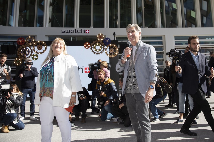 epa07891592 CEO Swatch Group Nick Hayek (R), speaks next to Nayla Hayek (L), chairwoman of the board of directors, during the official inauguration of the new head office building of the Swatch Group, ...