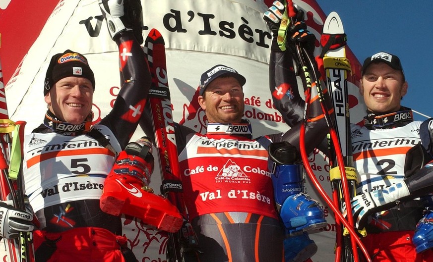 2th of the race and Swiss Didier Cuche, left, winner Austrian Stephan Eberharter, center and 3th Swiss Silvano Beltrametti, right, jubilate at the arrival area of the World Cup mens&#039;s Super-G, at ...