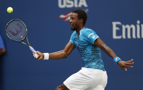 epa05532287 Gael Monfils of France hits a return to Novak Djokovic of Serbia during their semifinal round match on the twelfth day of the US Open Tennis Championships at the USTA National Tennis Cente ...
