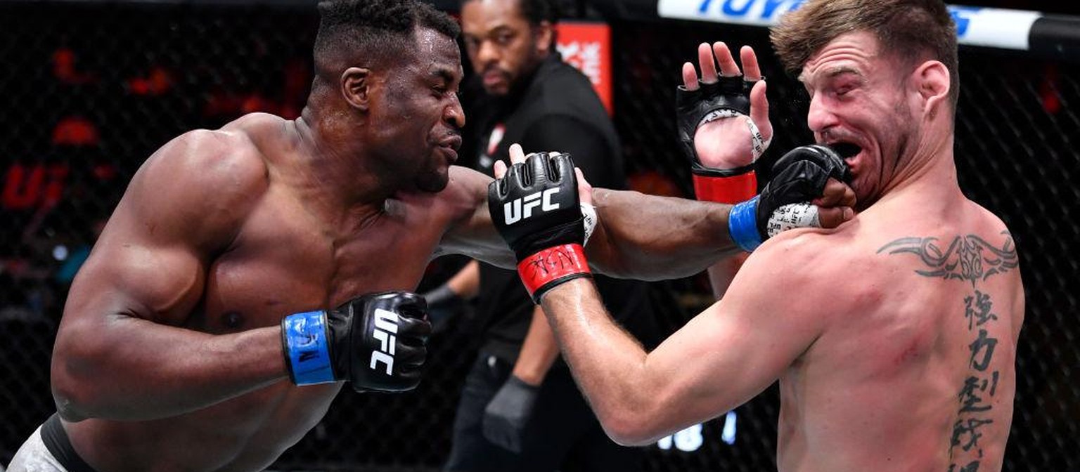 LAS VEGAS, NEVADA - MARCH 27: (L-R) Francis Ngannou of Cameroon punches Stipe Miocic in their UFC heavyweight championship fight during the UFC 260 event at UFC APEX on March 27, 2021 in Las Vegas, Ne ...