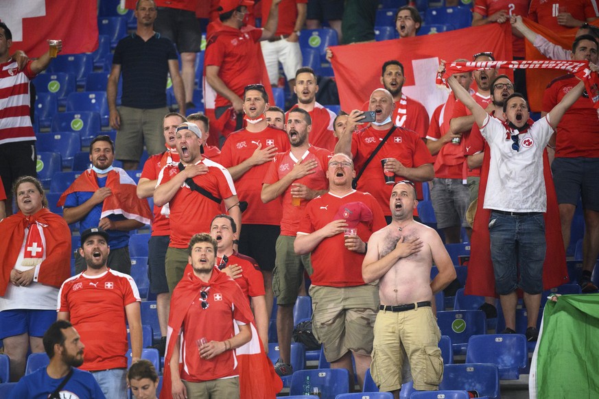 Supporters of the Swiss soccer team sing the national anthem during the Euro 2020 soccer tournament group A match between Italy and Switzerland at the Olympic stadium, in Rome, Italy, Wednesday, June  ...