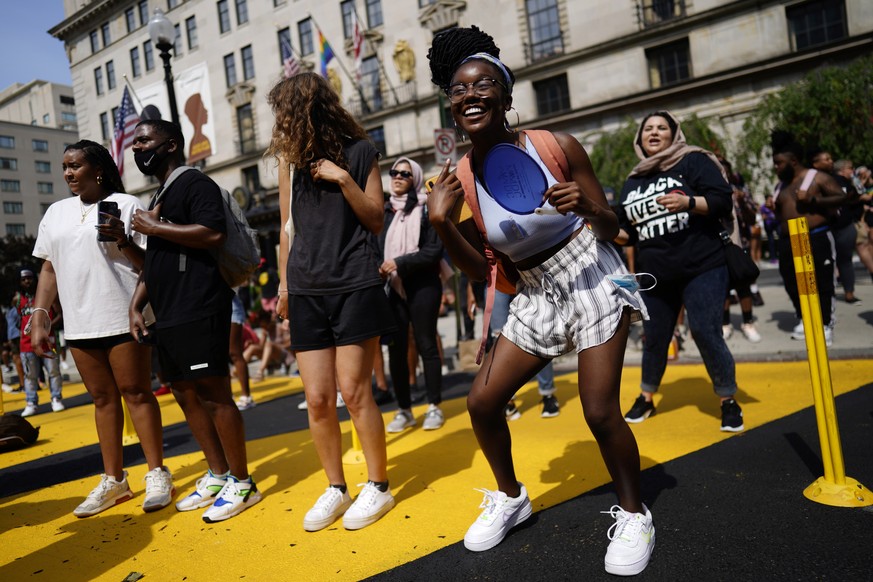 epa09287233 A member of the public dances as celebrations for &#039;Juneteenth&#039; take place on Black Lives Matter Plaza, in Washington, DC, USA, 19 June 2021. &#039;Juneteenth&#039; the celebratio ...