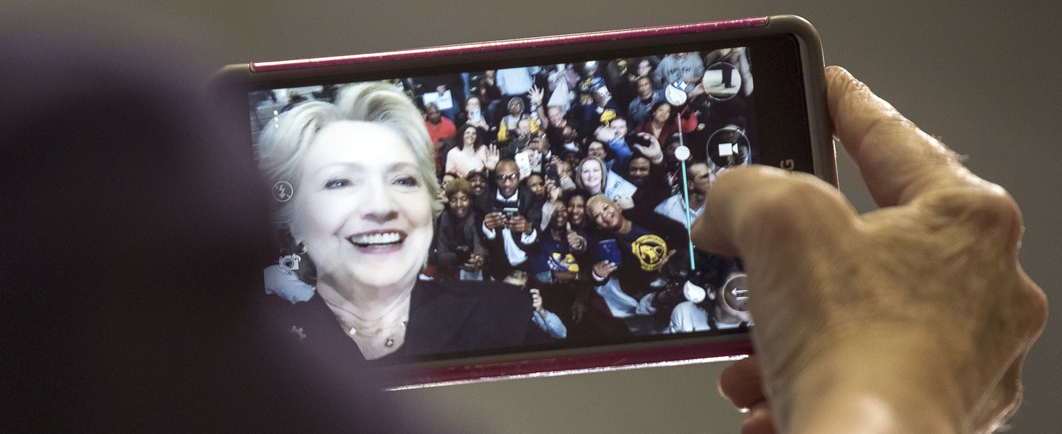 Democratic presidential candidate Hillary Clinton takes a group selfie with members of the audience after speaking at a rally at Wayne State University in Detroit, Monday, Oct. 10, 2016. (AP Photo/And ...
