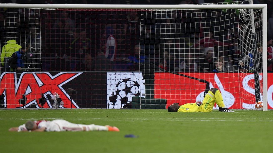 Ajax goalkeeper Andre Onana, right, reacts after Tottenham&#039;s Lucas Moura scores his side&#039;s third goal during the Champions League semifinal second leg soccer match between Ajax and Tottenham ...