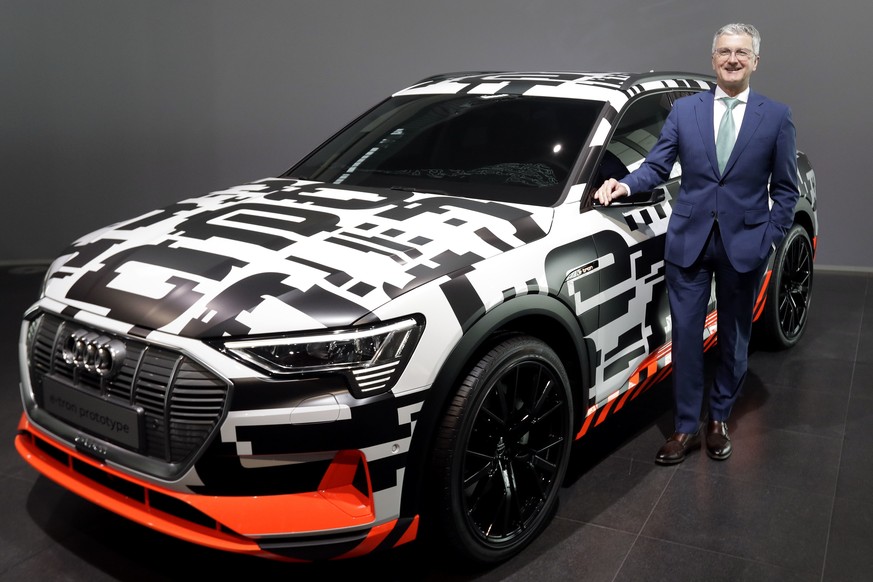 Rupert Stadler, CEO of German car producer Audi, poses besides an Audi e-tron prototype car prior to the annual press conference in Ingolstadt, Germany, Thursday, March 15, 2018. (AP Photo/Matthias Sc ...
