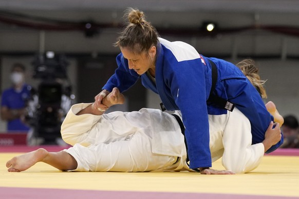 Fabienne Kocher of Switzerland, top, and Ana Perez Box of Spain compete during their women&#039;s -52kg round of 32 judo match at the 2020 Summer Olympics, Sunday, July 25, 2021, in Tokyo, Japan. (AP  ...