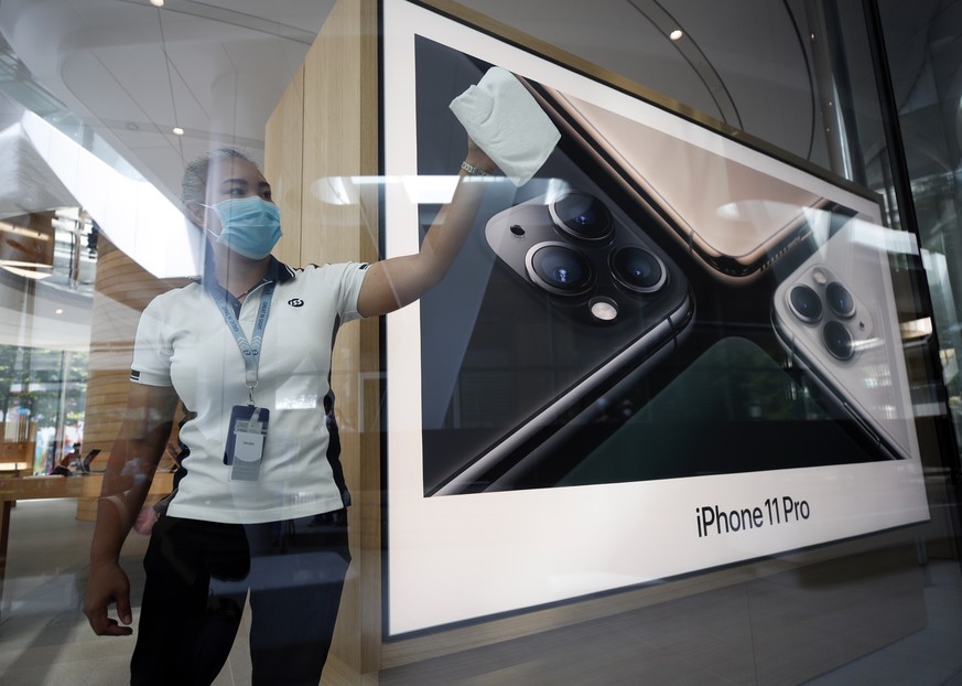 epa08575989 A Thai worker cleans a window of the new Apple Store in Bangkok, Thailand, 31 July 2020. Apple&#039;s second retail store is set to open at the Central World shopping complex, marking the  ...