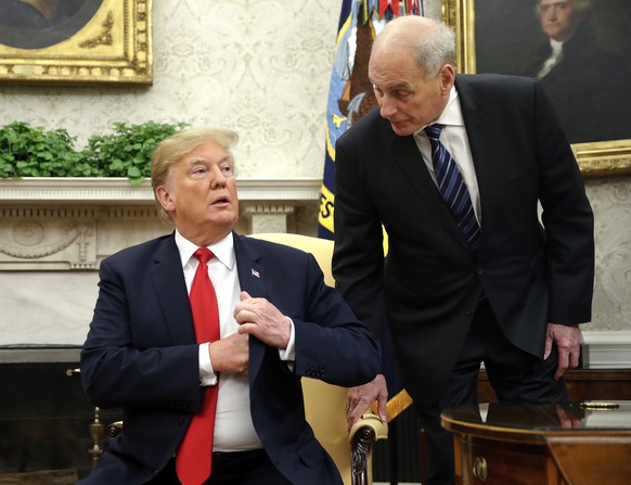 FILE - In this June 27, 2018 file photo, White House Chief of Staff John Kelly, right, leans in to talk with President Donald Trump during Trump&#039;s meeting with Portuguese President Marcelo Rebelo ...