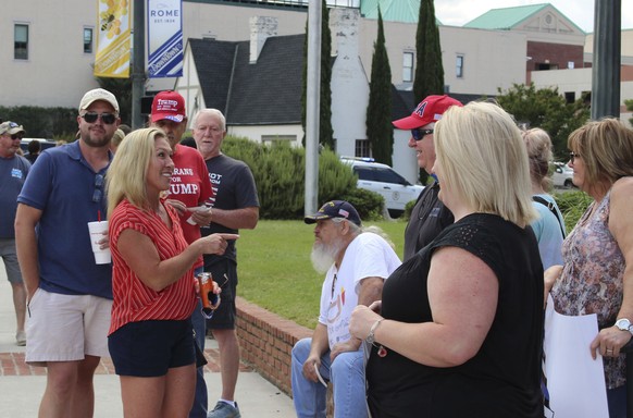 U.S. House District 14 candidate Marjorie Taylor Greene talks with attendees at a Back the Blue Rally in front of Rome City Hall on Monday, June 15, 2020 in Rome, Ga. Greene, in an Aug. 11 runoff for  ...