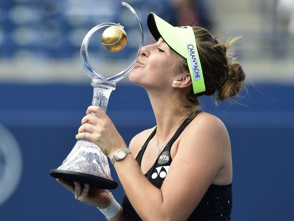 Belinda Bencic, of Switzerland, kisses the winner&#039;s trophy after defeating Simona Halep, of Romania, in the women&#039;s final at the Rogers Cup tennis tournament in Toronto, Sunday, Aug. 16, 201 ...