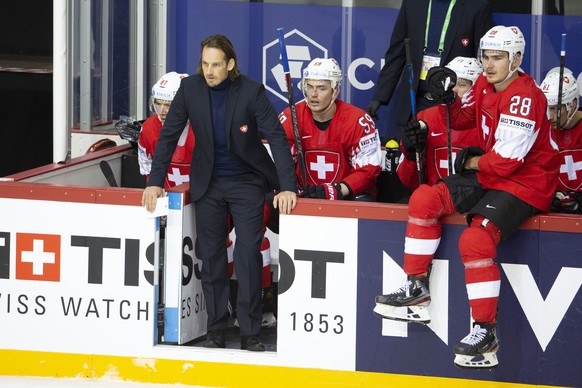 Patrick Fischer, head coach of Switzerland national ice hockey team, calls head referee past his players forward Killian Mottet, left, forward Dario Simion #59 left, and forward Timo Meier, right, dur ...