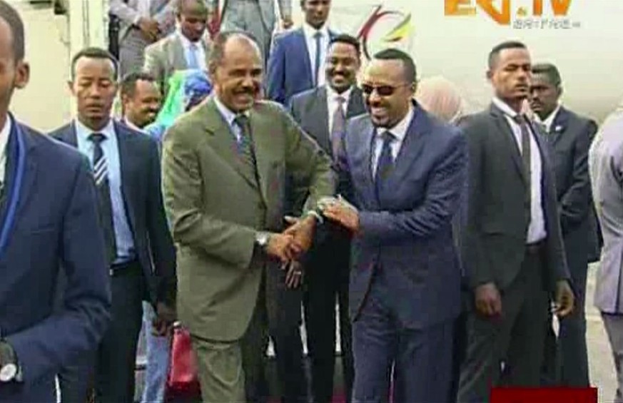 In this grab taken from video provided by ERITV, Ethiopia&#039;s Prime Minister Abiy Ahmed, centre right is welcomed by Erirea&#039;s President Isaias Afwerki as he disembarks the plane, in Asmara, Er ...