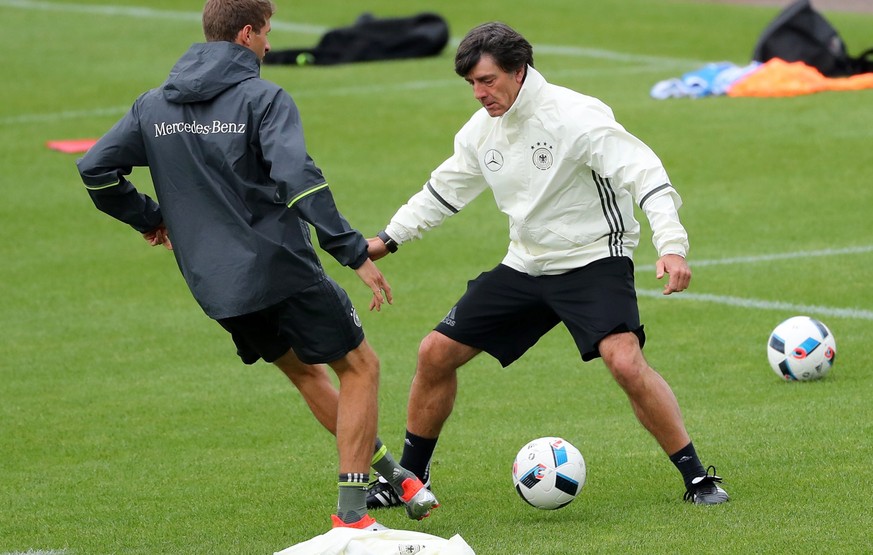 epa05364526 Germany&#039;s Thomas Mueller (L) nutmegs head coach Joachim Loew during the team&#039;s training session at their team hotel in Evian-les-Bains, France, 14 June 2016. Germany will face Po ...