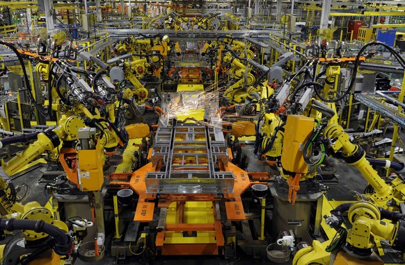 Robotic arms spot welds on the chassis of a Ford Transit Van under assembly at the Ford Claycomo Assembly Plant in Claycomo, Missouri April 30, 2014. REUTERS/Dave Kaup (UNITED STATES - Tags: BUSINESS  ...