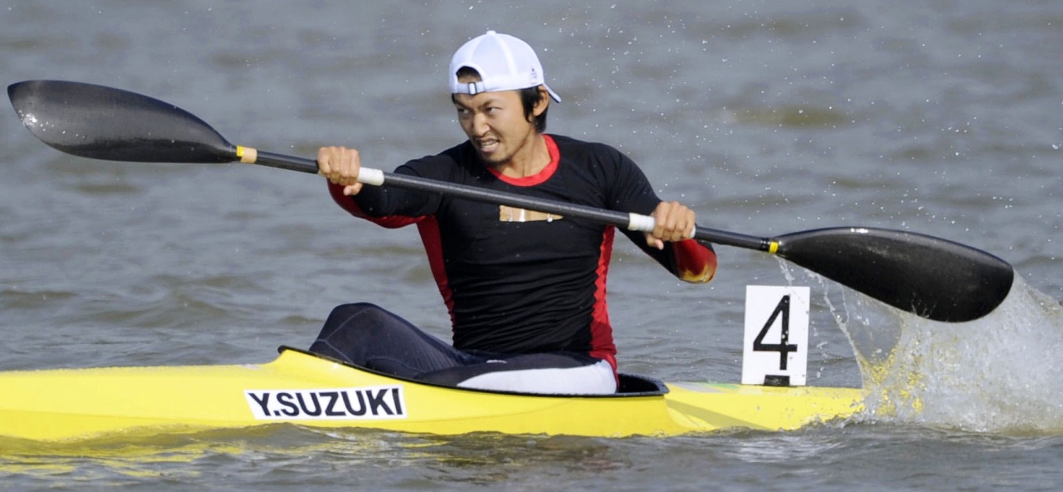 In this November 2010, photo, Japan&#039;s Yasuhiro Suzuki competes in the mens single kayak race at the 16th Asian Games in Shanwei, China. The top Japanese canoe sprinter has been banned for eight y ...