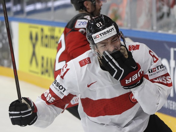 Switzerland&#039;s Fabrice Herzog celebrates after scoring his sides winning goal during the Ice Hockey World Championships group B match between Canada and Switzerland in the AccorHotels Arena in Par ...