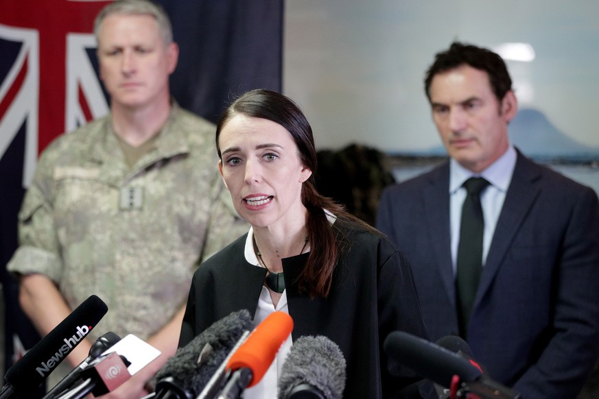 epa08067680 New Zealand Prime Minister Jacinda Ardern (C), flanked by New Zealand Army Colonel Ryan McKinstry (L) and Police Minister Stuart Nash (R), speaks during a media conference following a reco ...