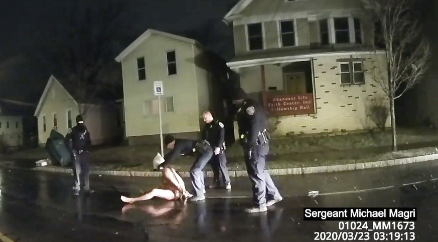 FILE- In this March 23, 2020 file image made from police body camera video provided by Roth and Roth LLP, a Rochester police officer puts a spit hood over the head of Daniel Prude in Rochester, N.Y. O ...
