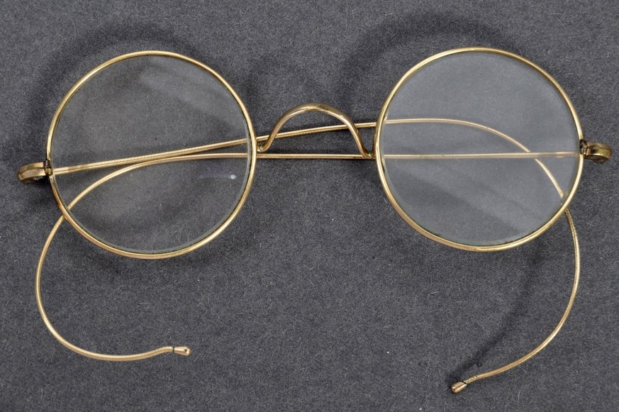 In this image provided by East Bristol Auctions and taken in Bristol, England on July 20, 2020 a pair of eyeglasses that are believed to have once belonged to Mohandas Gandhi are laid out on display.  ...