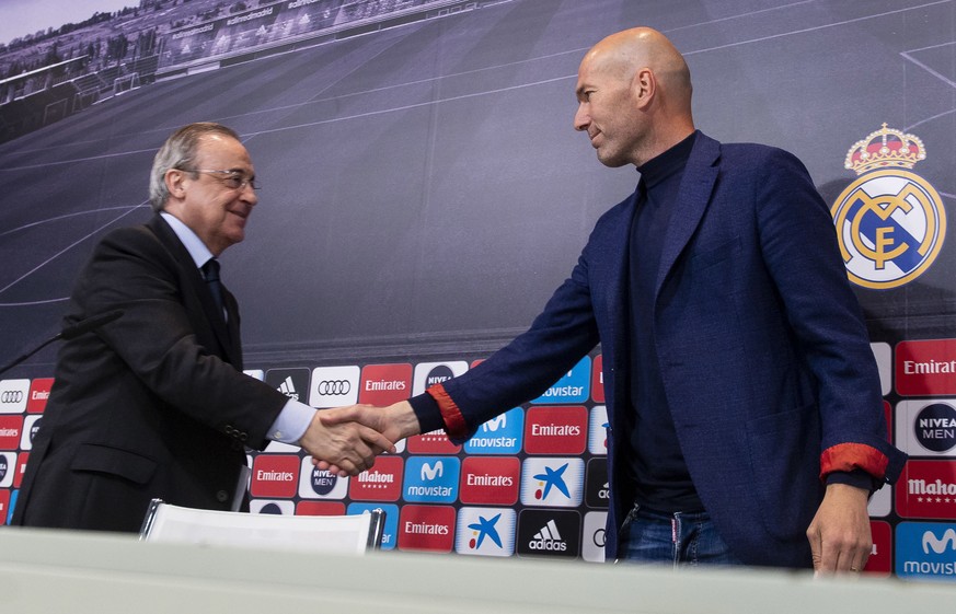 Zinedine Zidane shakes hands with President of Real Madrid, Florentino Perez, during a press conference in Madrid, Spain, Thursday, May 31, 2018. Zinedine Zidane quit as Real Madrid coach on Thursday, ...